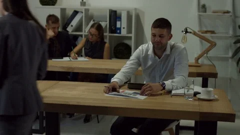Secretary giving documents to managers in office Stock Footage 85356860
