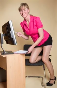 Secretary in an office with computer screen Stock Photos