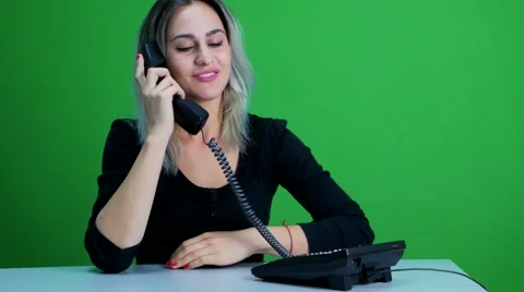 Secretary picks up the phone and talking on the phone. green screen studio Stock Footage