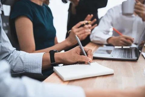 Secretary taking notes on notebook at corporate meeting. Concord Stock Photos
