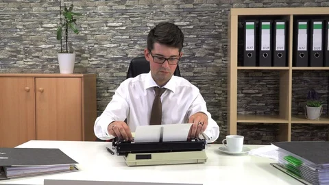 Secretary is typing at a table with a cup of coffee in the workplace Stock Footage 115833176