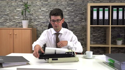 Secretary is typing at a table with a cup of coffee in the workplace Stock Footage 116271587