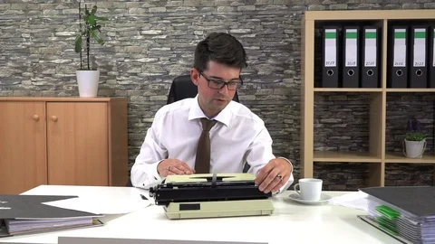 Secretary is typing at a table with a cup of coffee in the workplace Stock Footage 116609298