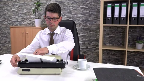 Secretary is typing at a table with a cup of coffee in the workplace Video stock 117334801