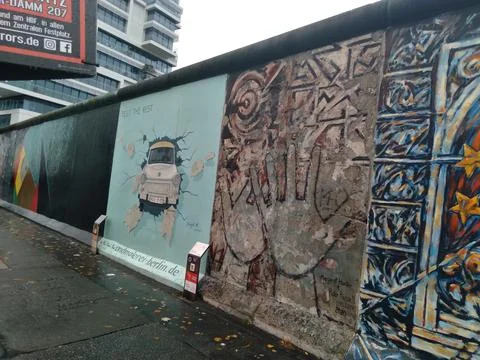 A section of the Berlin Wall featuring famous street art Photos