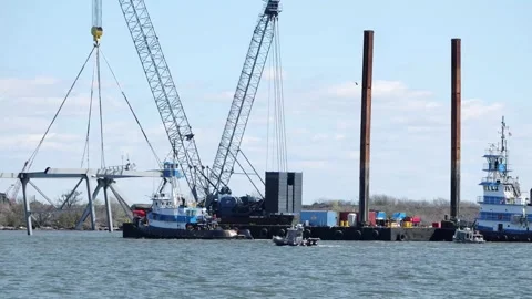 Section of the collapsed Francis Scott Key Bridge truss is transported by barge Stock Footage 271338129