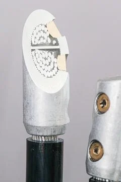 Section of an electrical power cable with a metallic connector. Industrial cable Stock-Fotos