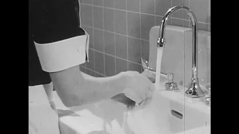 A section of a handwashing tutorial video from the 1960s shows a nurse Stock Footage 145481296