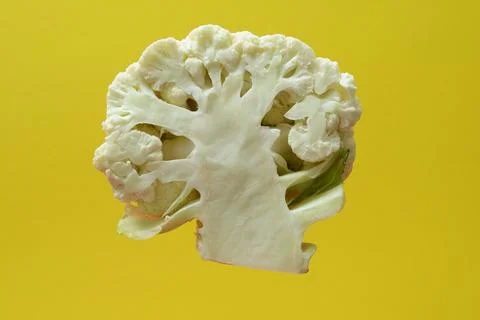 Section of a head of cauliflower on a yellow backdrop Stock Photos