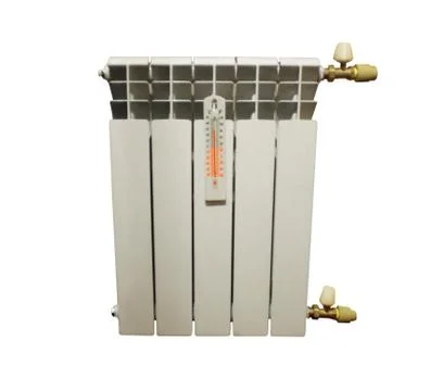 Section of a heating battery with a thermometer on a white background Stock Photos