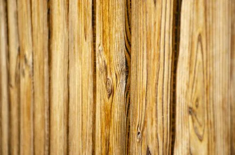 A section of light brown, vertical, overlapped wooden garden fence in closeup Stock Photos