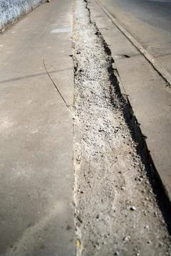 Section of paved sidewalk, skillfully excavated for the installation of elect Stock Photos