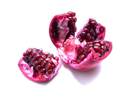 Section of pomegranate isolated on white background. Stock Photos