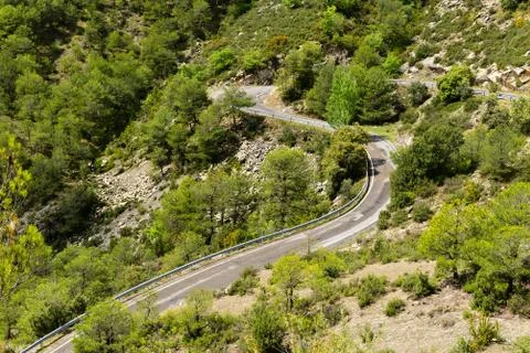 A section of road with bends going through  mountainous countryside Stock Photos