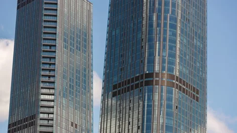 Section of skyscrapers and reflection of clouds on glass facade Stock Footage 135305183