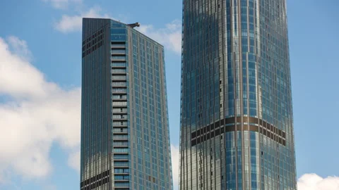 Section of skyscrapers and reflection of clouds on glass facade Stock Footage 135306549