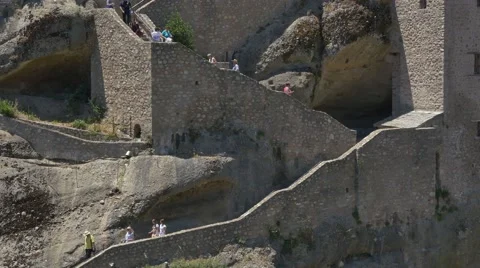 Section of stone stairway leading to a monastery with visitors going up and down Stock Footage 67717727