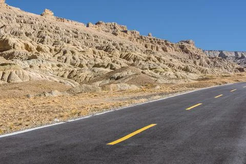 A section of tarmac road in the eroded landscape and rock towers of Zanda soi Stock Photos