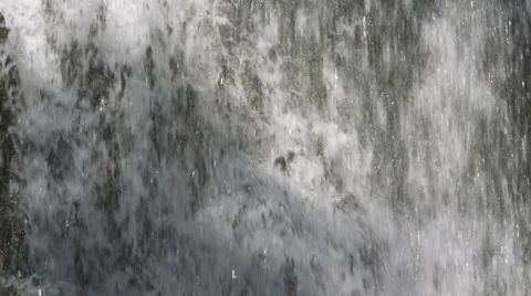 A section of waterfall streaming over a mossy cliff face Stock Footage 59529288