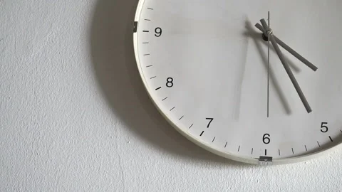 Section of a white face wall clock with silver handles and black numbers wi.. Stock Footage 317499925