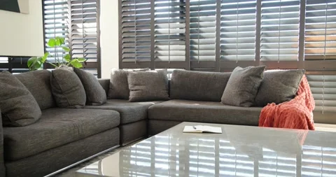 Sectional sofa is sitting in corner as camera is panning right, revealing Stock Footage 344403551