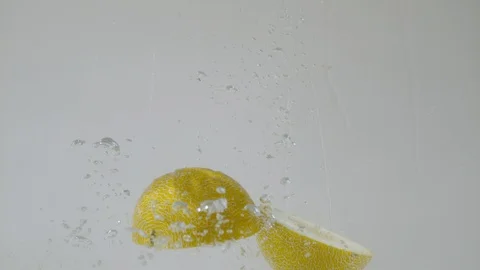 Sectioned honeymelon falling into water, Ultra Slow Motion Stock Footage 86583465