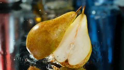Sectioned pears dropped into the table with water, Ultra Slow Motion, 4k Stock Footage 114965790
