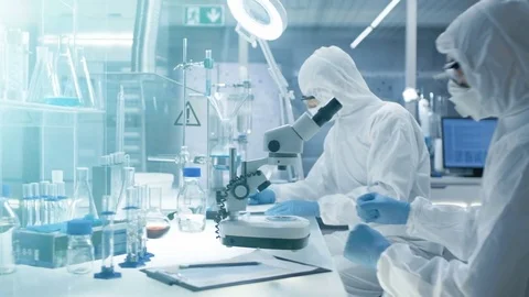 In a Secure High Level Laboratory Scientists in a Coverall Conducting a Research Stock Footage