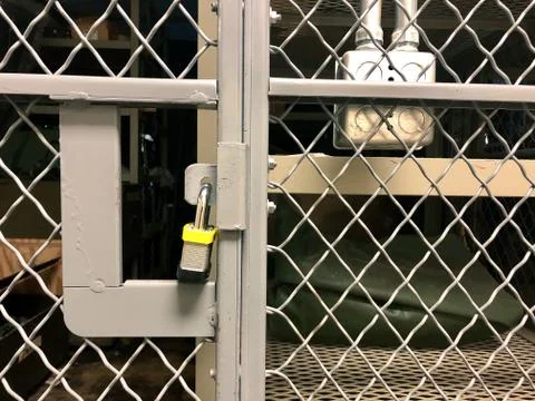 Secure Padlock chained to Army Supply Cage Stock Photos