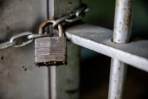 Secure Padlock on Rusty Metal Gate with Chain Stock Photos