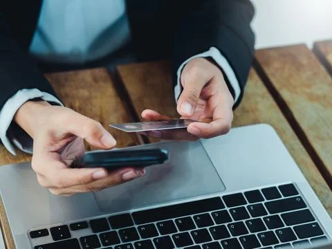 Secure payment concept. Protection shield icon on credit card holding by bu.. Stockfoto's