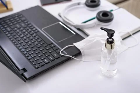 Secure remote work, protective equipment, sanitizer, medical mask, headphones Stock Photos