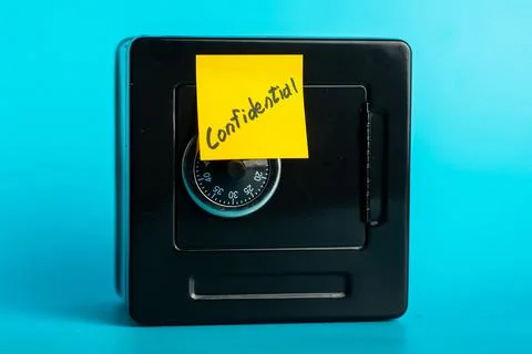 Secure safe with confidential sticky note against blue background 写真素材