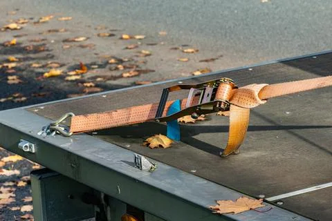 Secure strap on a flatbed trailer during autumn season Fotos Stock