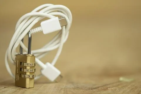 Secure USB-C cable with brass combination lock for data protection concept Stock Photos