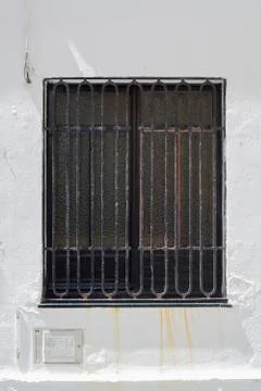 Secure window in a white washed wall Stock Photos