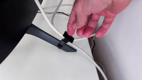 Securing Cable with Clip for Organized Workspace Setup Stock-Footage 330631868