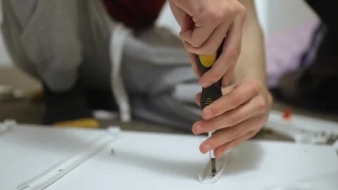 Securing drawer slide on panel during dresser assembling Stock Footage 328370595