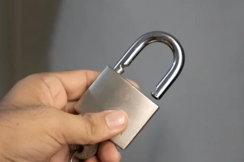 Securing the Future: A Man Holds a Key Lock Stock Photos