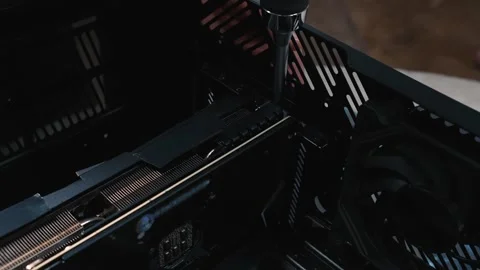 Securing installed graphics card inside computer case using screwdriver Stock Footage 335070370