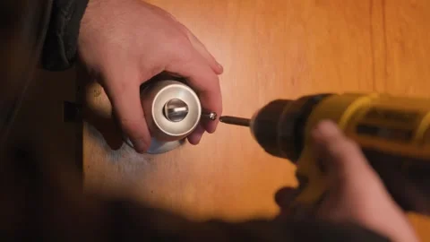 Securing the knob into the hole. Stockbeeldmateriaal 327368186