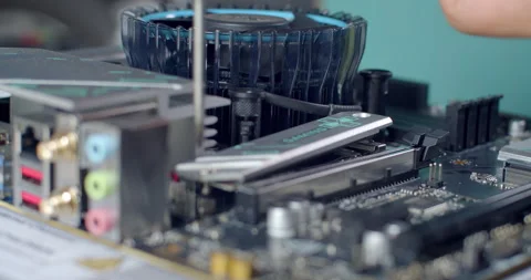 Securing the M.2 SSD heatsink with a screw after installation. Stock Footage 311939341