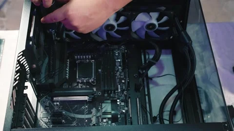 Securing motherboard inside gaming computer case with screwdriver Stock Footage 328985353