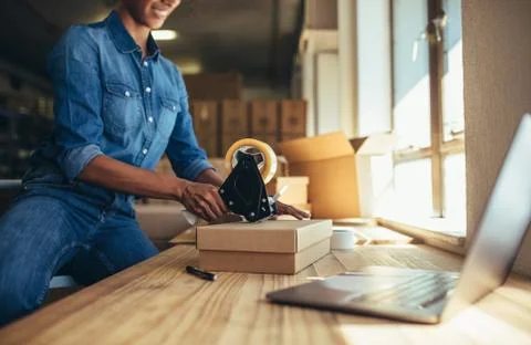 Securing the parcel with tape Stock Photos