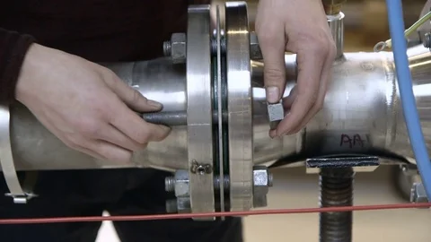 Securing a pipe with bolt and screw Stock Footage 81809840