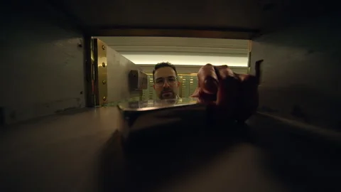 Securing valuables in a safe deposit box at the bank ensures their safety Stock Footage 276565900