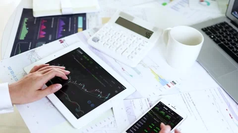 Securities analysts use tablets to watch and trade stocks Video stock 170592061