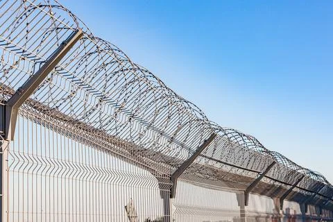 Security with a barbed wire fence Stock Photos