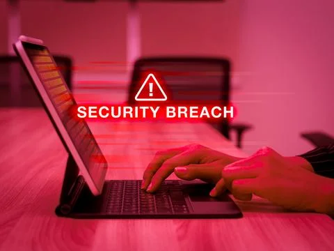 Security breach warning on digital tablet screen computer with red alert. D.. Stock Photos