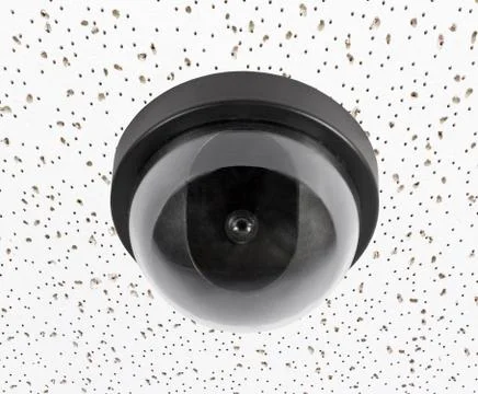 Security camera on acoustic tile ceiling Stock Photos